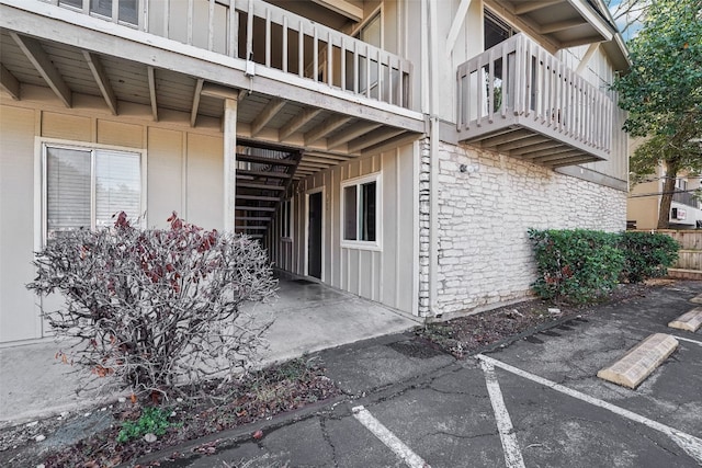 view of side of property with a balcony and a patio area