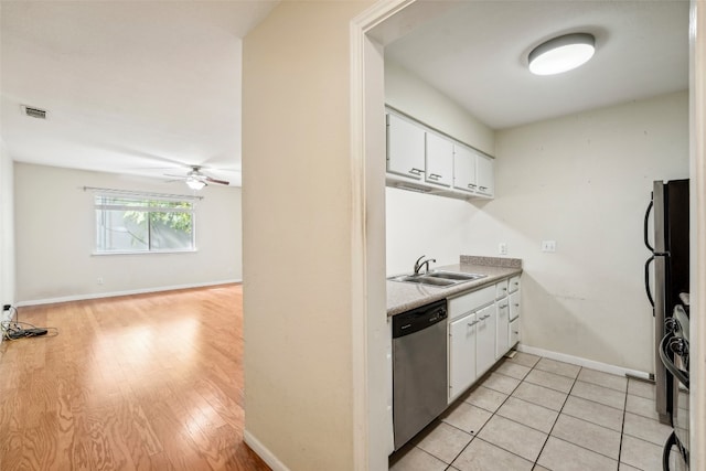 kitchen featuring light hardwood / wood-style floors, sink, stainless steel dishwasher, white cabinetry, and fridge