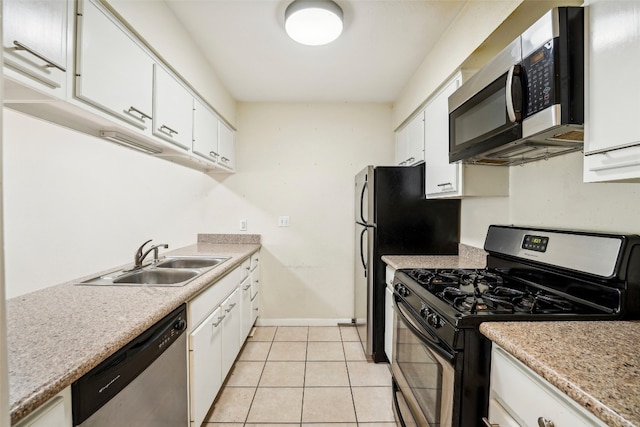 kitchen with white cabinetry, sink, light tile patterned floors, and stainless steel appliances