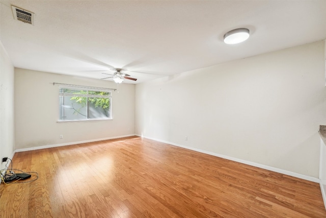 spare room featuring light hardwood / wood-style flooring and ceiling fan