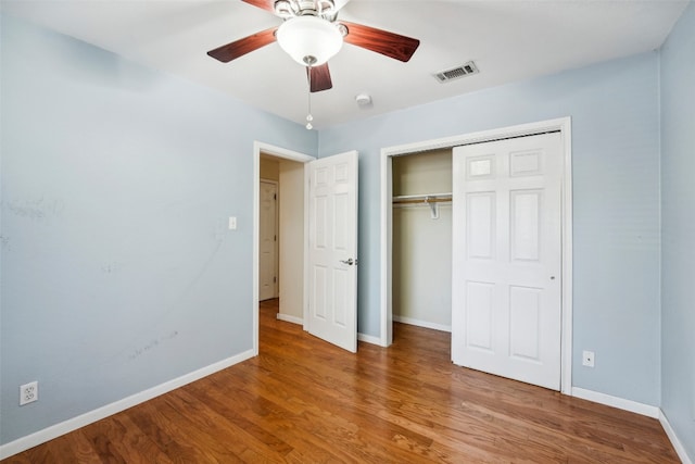 unfurnished bedroom with a closet, wood-type flooring, and ceiling fan