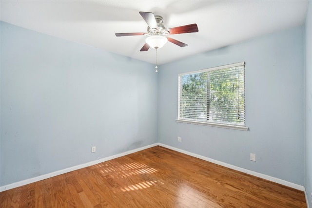 spare room with hardwood / wood-style flooring and ceiling fan