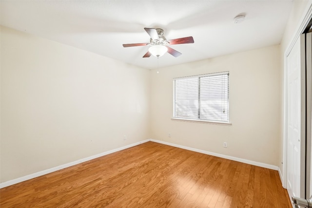 unfurnished bedroom with light wood-type flooring, ceiling fan, and a closet