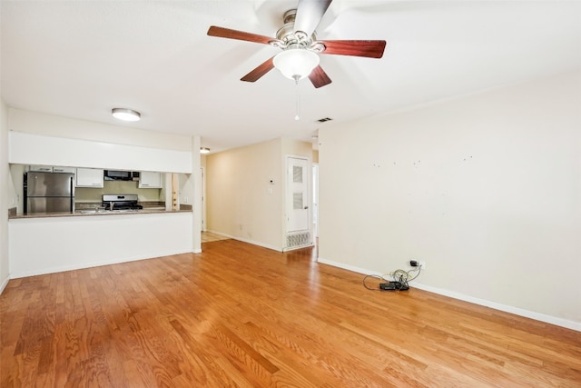 unfurnished living room featuring light hardwood / wood-style floors and ceiling fan