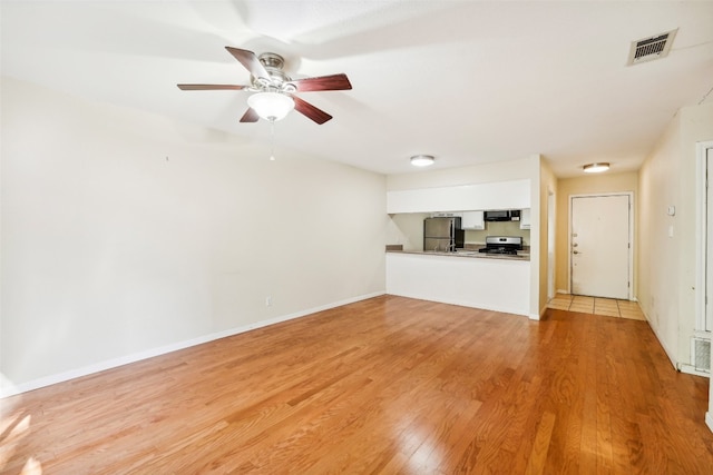 unfurnished living room with light hardwood / wood-style flooring and ceiling fan