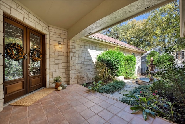 property entrance featuring a patio area and french doors