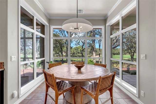 sunroom featuring a wealth of natural light and an inviting chandelier