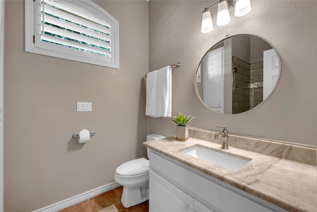 bathroom with walk in shower, tile patterned flooring, vanity, and toilet