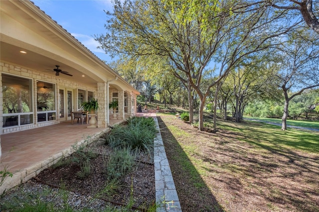 view of yard featuring a patio and ceiling fan