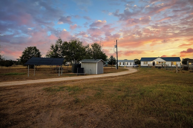 yard at dusk with a storage shed