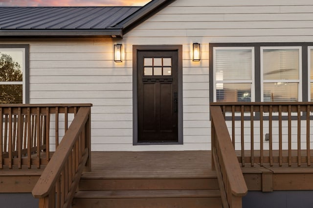 exterior entry at dusk with a deck