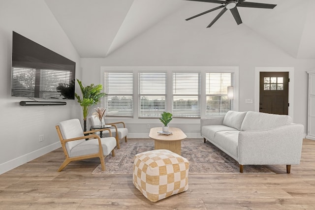 living room with light wood-type flooring, plenty of natural light, ceiling fan, and high vaulted ceiling