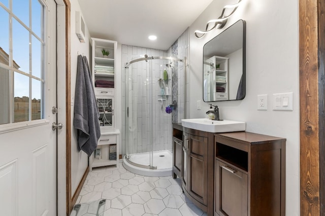 bathroom with tile patterned flooring, vanity, and a shower with door