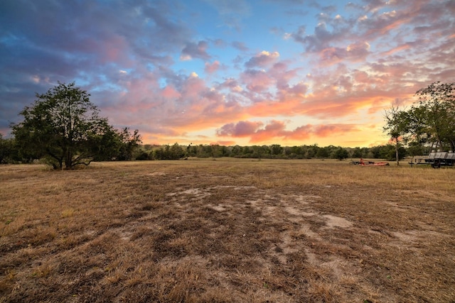 nature at dusk featuring a rural view