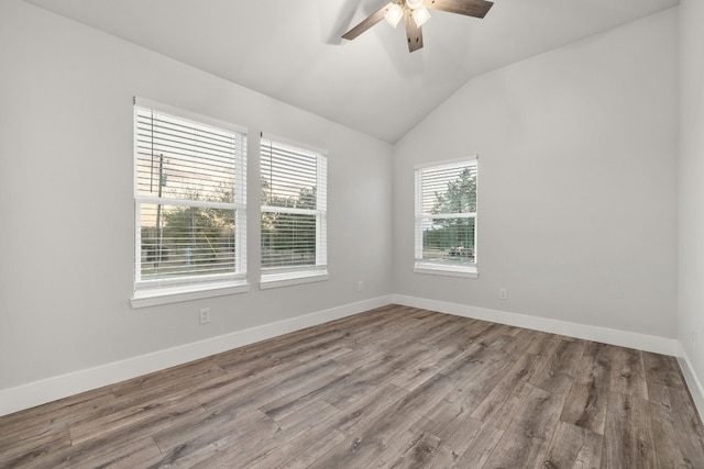 spare room with wood-type flooring, ceiling fan, and vaulted ceiling