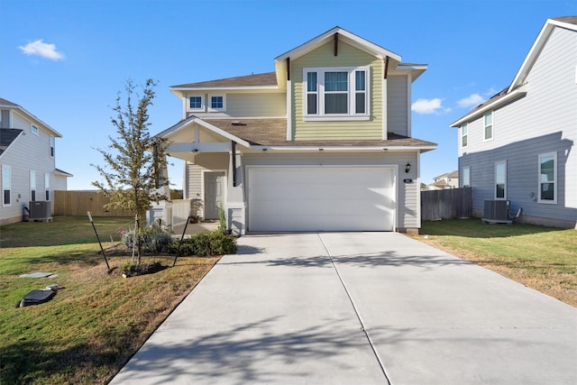 view of front of home featuring central AC, a garage, and a front lawn