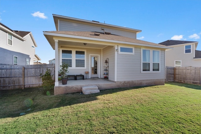 back of house featuring a yard and a patio area