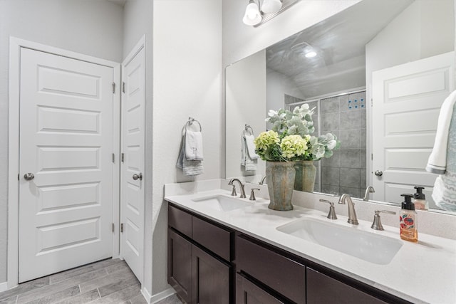 bathroom featuring hardwood / wood-style floors, vanity, and walk in shower