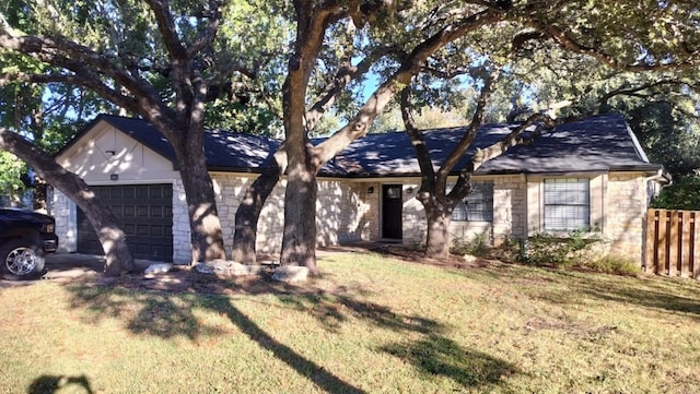 ranch-style home featuring a garage and a front yard