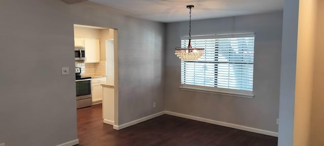 dining area featuring a chandelier and dark hardwood / wood-style floors