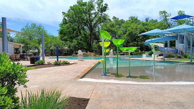 view of pool with a patio and a water slide