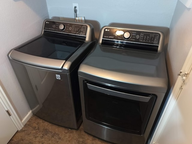 clothes washing area featuring washing machine and clothes dryer