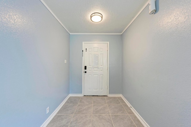 doorway with light tile patterned flooring, a textured ceiling, and ornamental molding