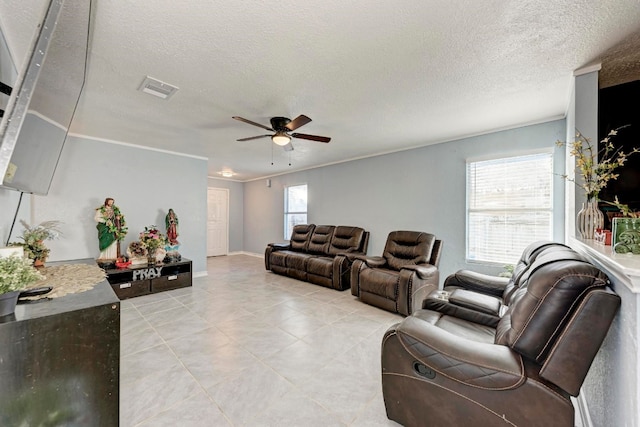 living room featuring a textured ceiling, ceiling fan, and crown molding