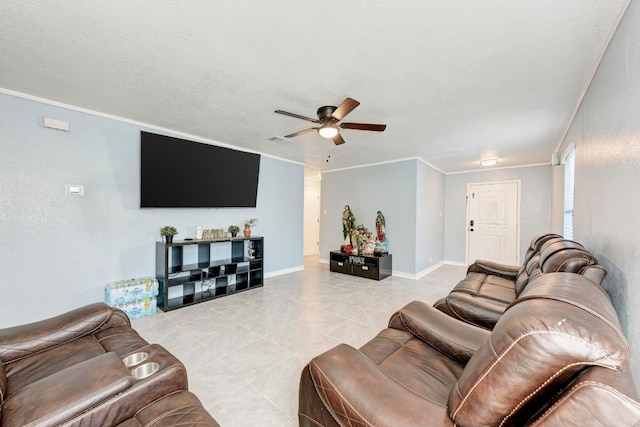 living room with ceiling fan, ornamental molding, a textured ceiling, and light tile patterned floors