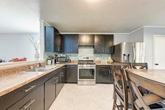 kitchen featuring stainless steel appliances, a textured ceiling, decorative backsplash, sink, and light tile patterned flooring