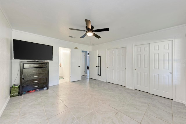 unfurnished bedroom featuring ornamental molding, two closets, and ceiling fan