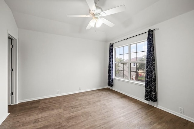 spare room featuring ceiling fan and dark wood-type flooring