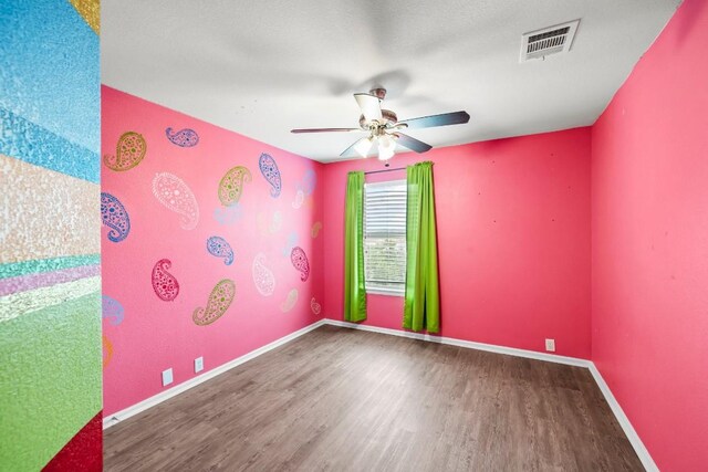 empty room with hardwood / wood-style flooring and ceiling fan