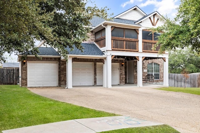 view of front facade with a balcony and a front lawn