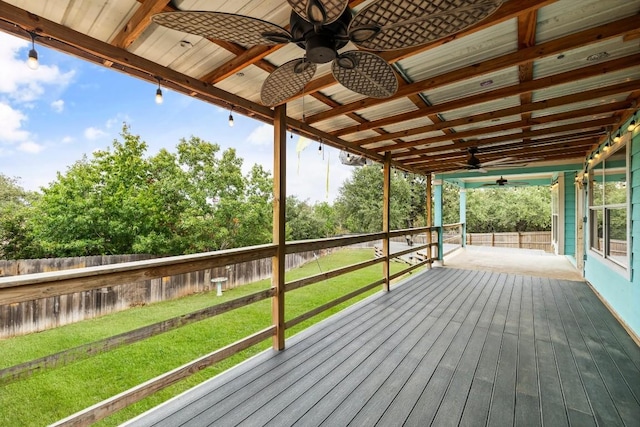 wooden deck featuring a lawn