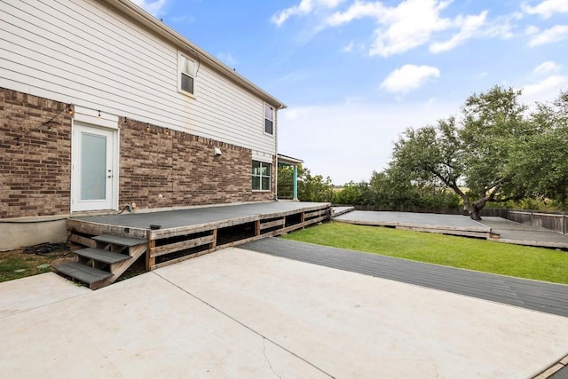 view of side of home featuring a deck and a lawn