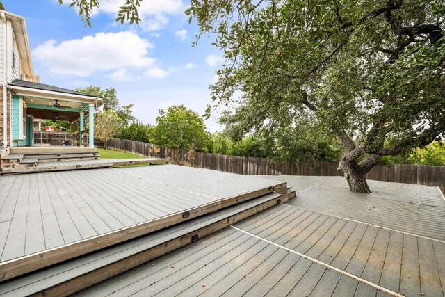 wooden terrace featuring ceiling fan