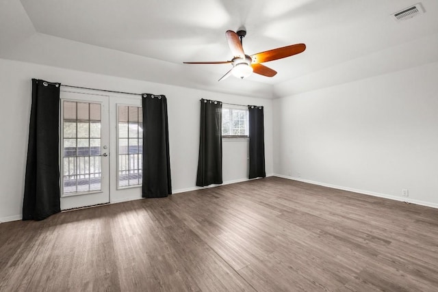 unfurnished room with ceiling fan, dark wood-type flooring, and french doors