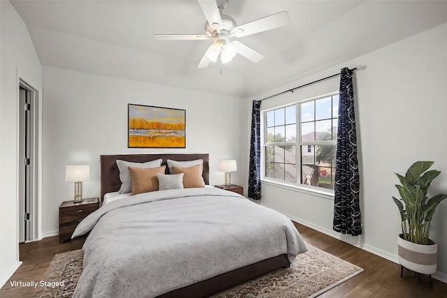 bedroom featuring ceiling fan and dark wood-type flooring