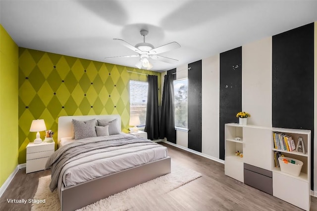 bedroom featuring ceiling fan and hardwood / wood-style flooring