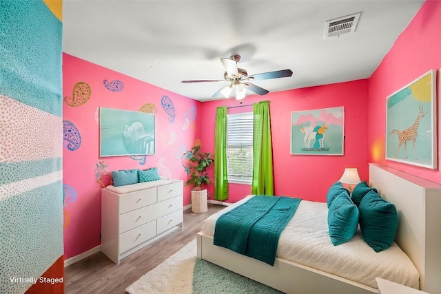 bedroom with ceiling fan and light hardwood / wood-style flooring