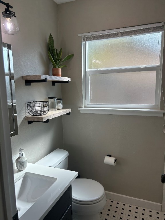 bathroom with tile patterned floors, vanity, and toilet