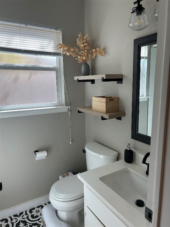 bathroom with tile patterned floors, vanity, and toilet