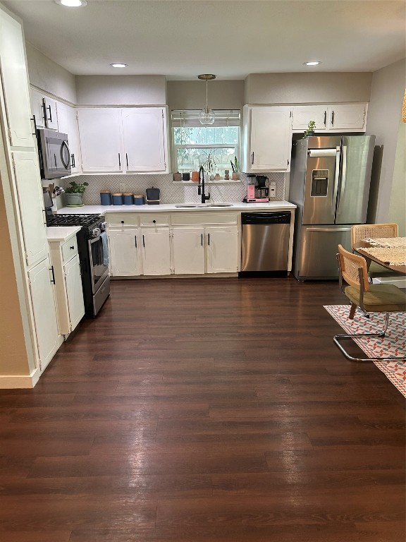 kitchen featuring white cabinets, stainless steel appliances, sink, and dark hardwood / wood-style floors