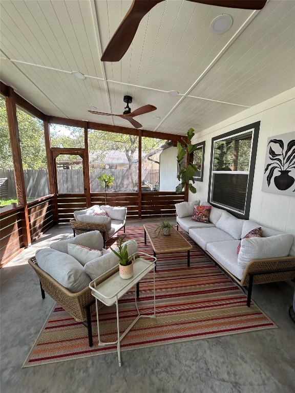 sunroom featuring ceiling fan