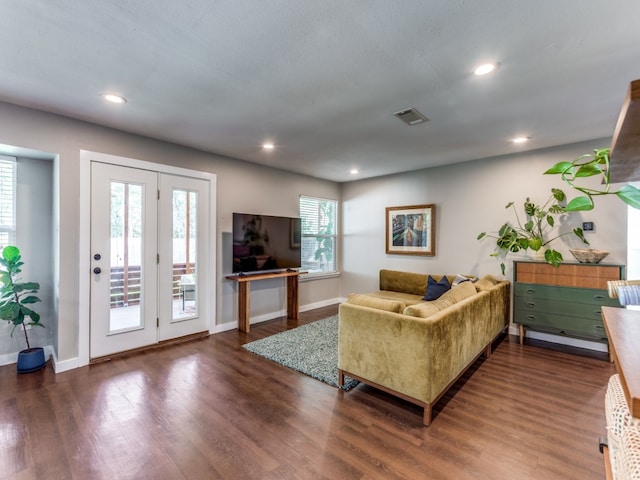 living room featuring dark hardwood / wood-style flooring and plenty of natural light