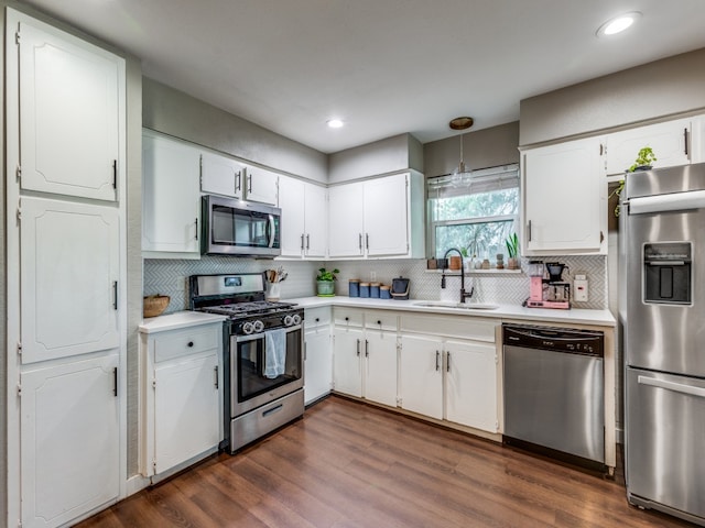 kitchen featuring white cabinets, stainless steel appliances, dark wood-type flooring, and sink