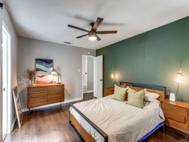 bedroom with ceiling fan and dark hardwood / wood-style flooring