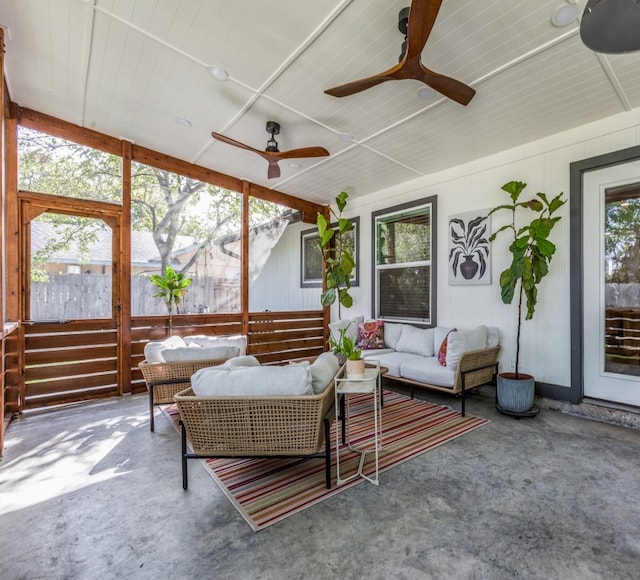 sunroom with plenty of natural light and ceiling fan