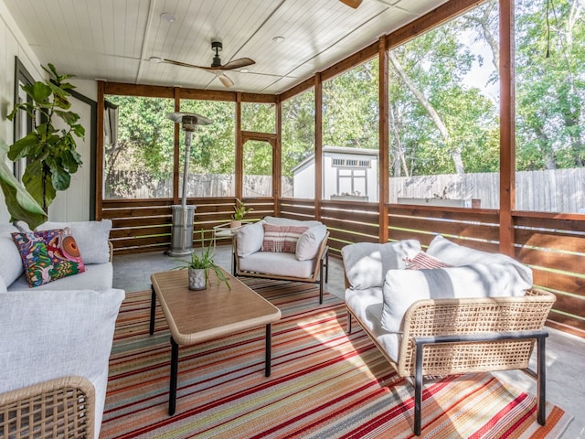 sunroom / solarium featuring wooden ceiling and ceiling fan